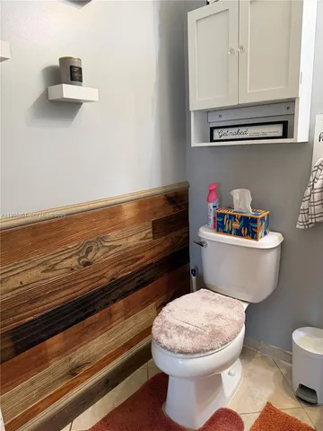 a bathroom with a toilet a sink and a mirror