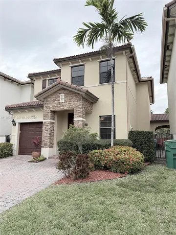 a front view of a house with a garden