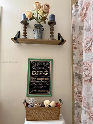 a room with a vase and flowers on it