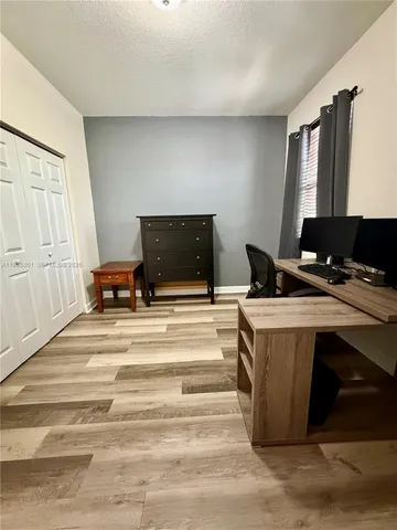 a view of a livingroom with furniture and cabinet