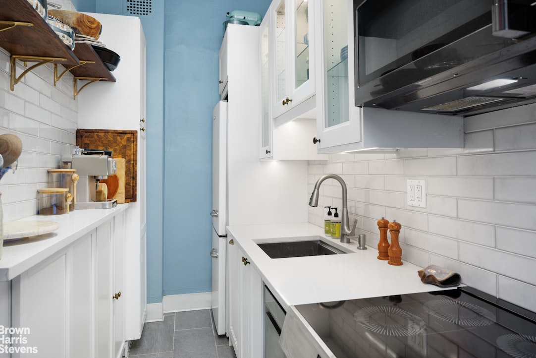 292 Riverside Drive, Unit 3A Manhattan, NY 10025 - Photo 4 of 11 a kitchen with a sink a stove and cabinets