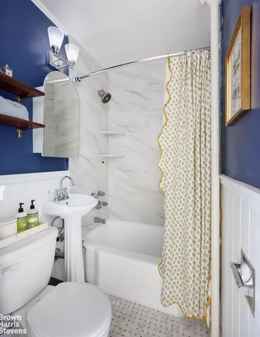 a bedroom with a bed a large window with table and chair