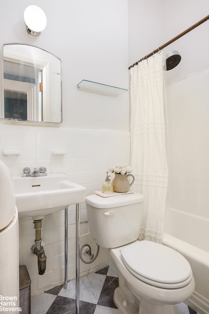 292 Riverside Drive, Unit 3A Manhattan, NY 10025 - Photo 8 of 11 a bathroom with a sink a toilet and a mirror