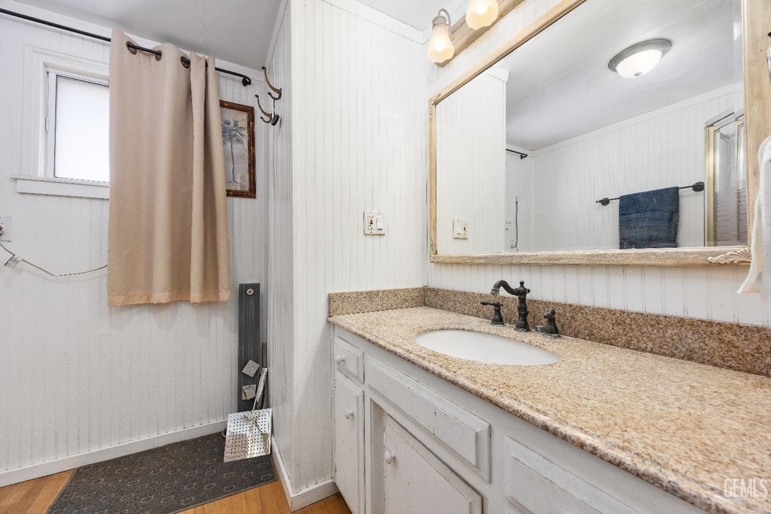 Undisclosed Address Edwards, CA 93523 - Photo 40 of 71 a bathroom with a granite countertop sink a mirror and a shower