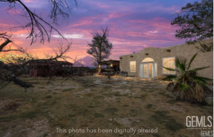 Undisclosed Address Edwards, CA 93523 - Photo 4 of 71 a front view of a house with a yard