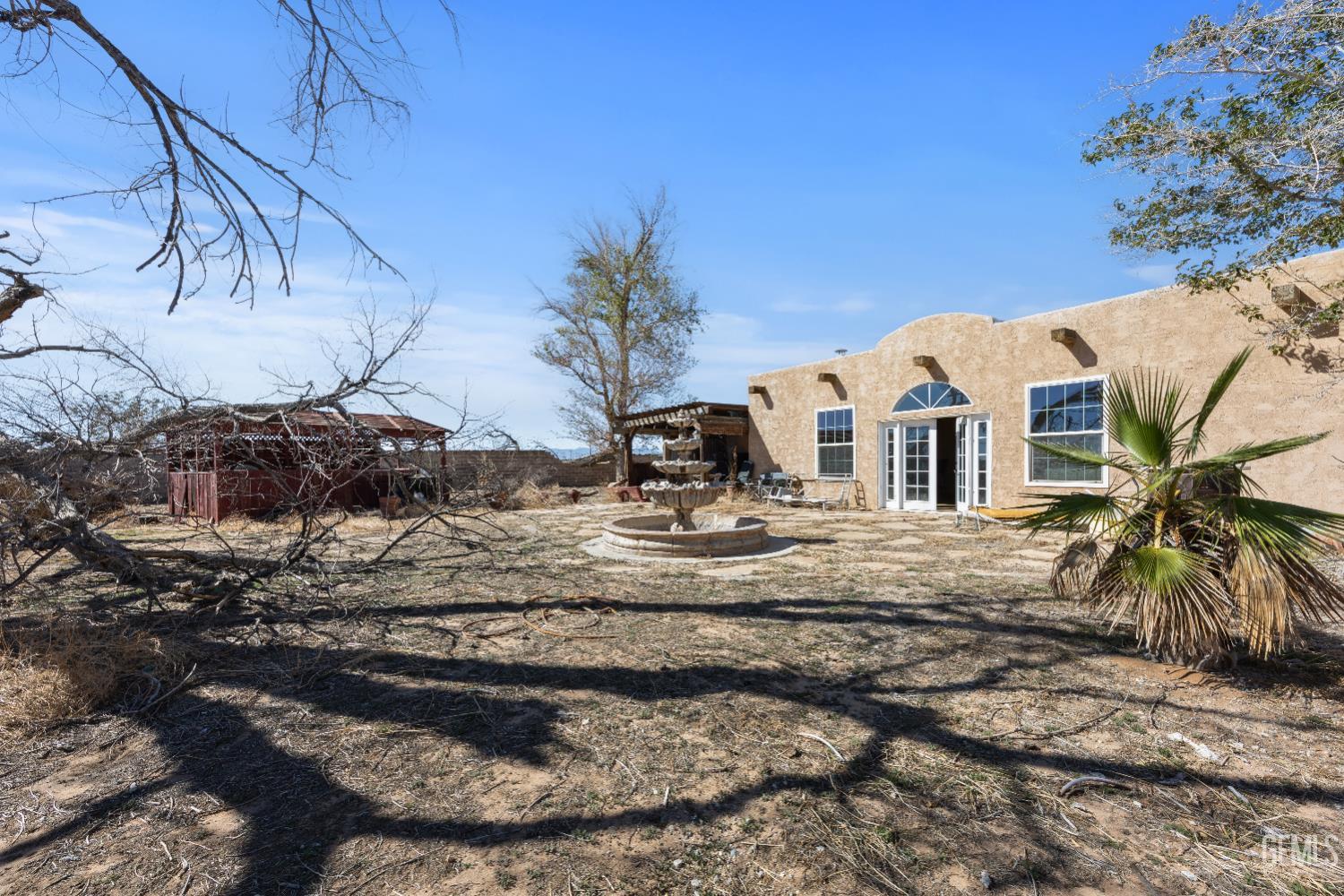 Undisclosed Address Edwards, CA 93523 - Photo 53 of 71 a view of a white house with a yard