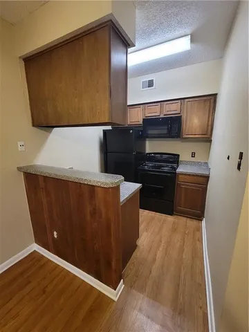 a kitchen with wooden cabinets and a stove top oven