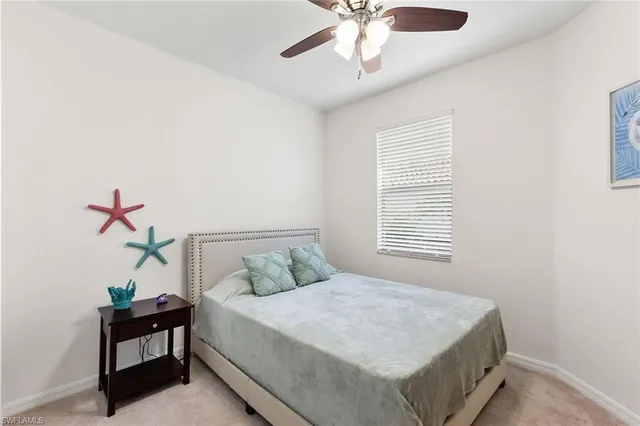 a bathroom with a granite countertop sink a toilet a mirror a bathtub and shower