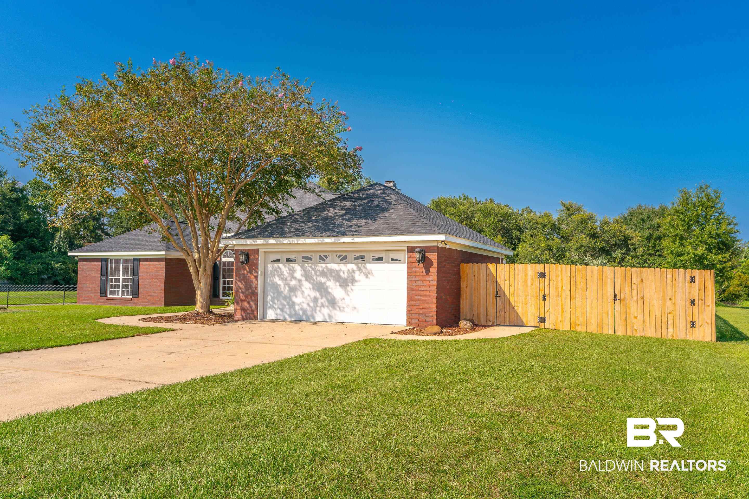 9477 Deerfield Drive Irvington, AL 36544 - Photo 56 of 58 View of front facade with a garage and a front lawn