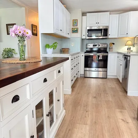 a kitchen with stainless steel appliances a stove a microwave and cabinets