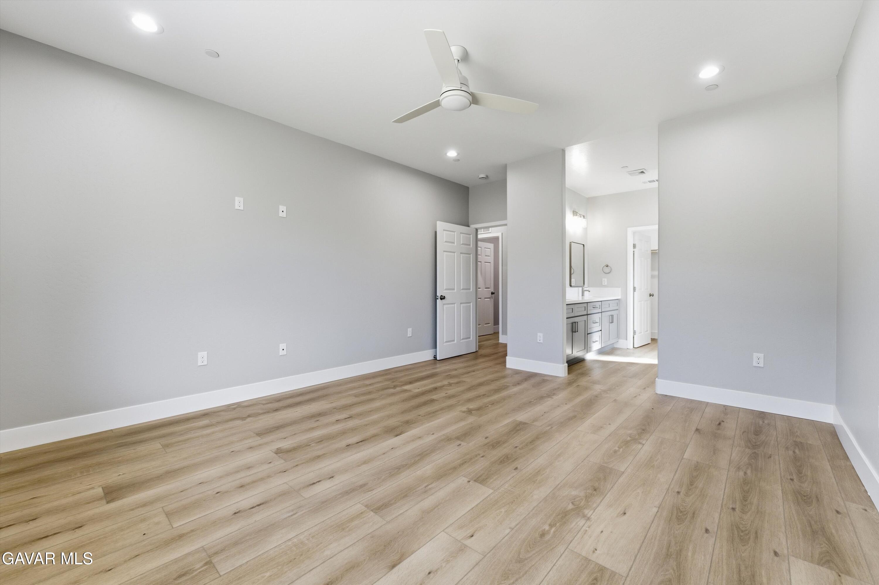 22613 Royal Place Tehachapi, CA 93561 - Photo 14 of 26 a view of a livingroom with a ceiling fan window and wooden floor