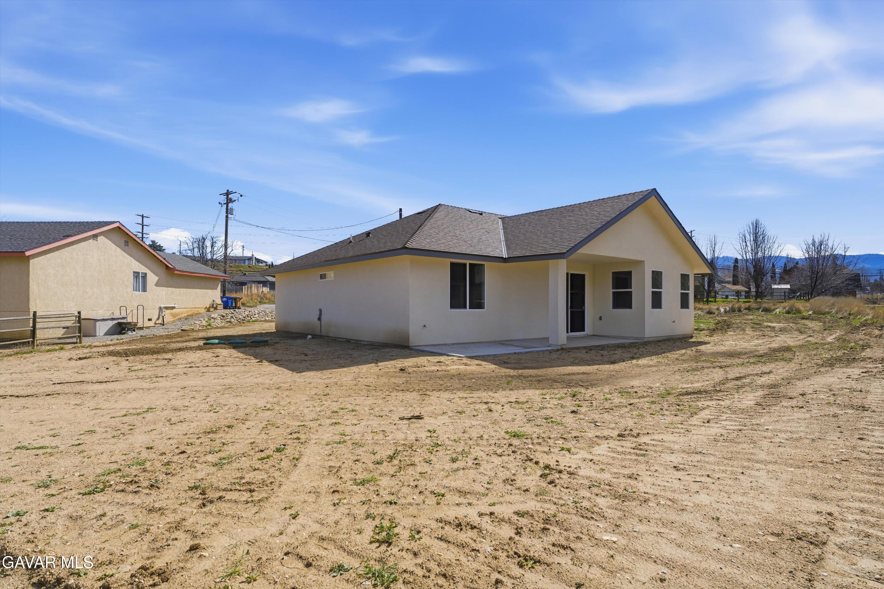 22613 Royal Place Tehachapi, CA 93561 - Photo 20 of 26 a view of a house with wooden fence