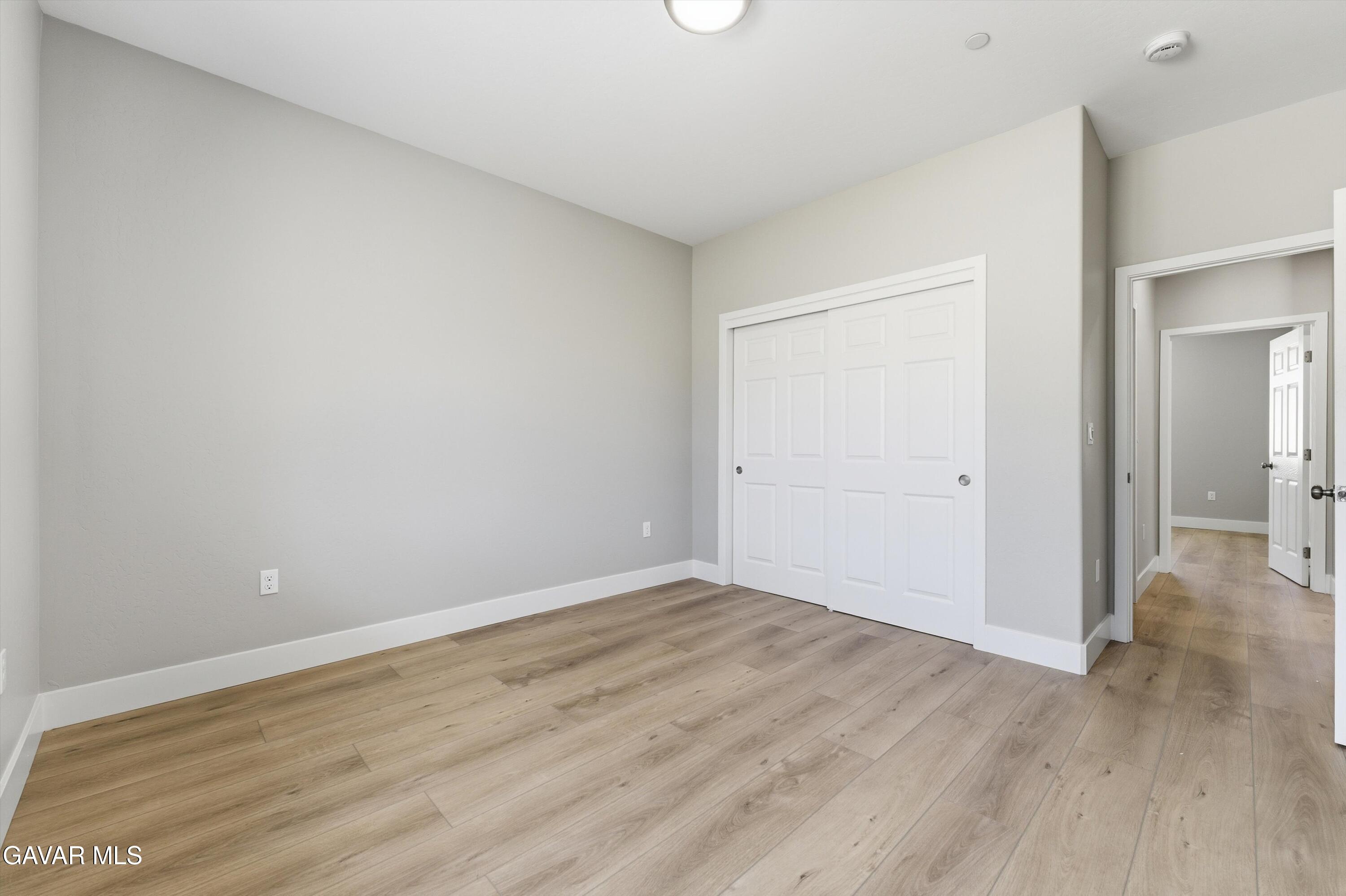 22613 Royal Place Tehachapi, CA 93561 - Photo 9 of 26 a view of an empty room and wooden floor