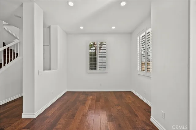 a view of hallway with stairs and wooden floor