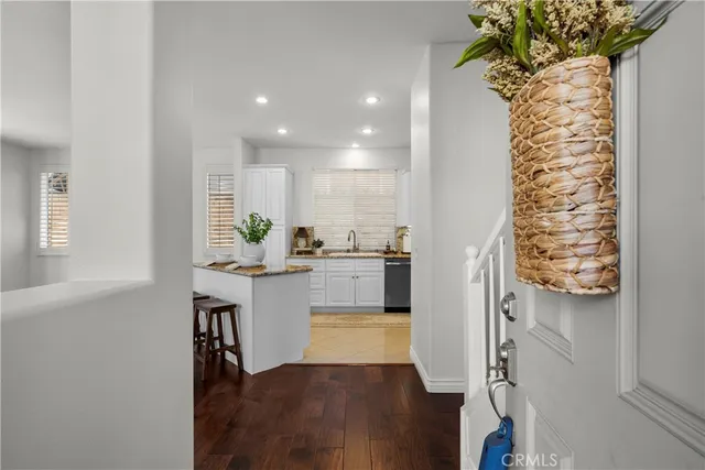 a kitchen with stainless steel appliances a white stove top oven and a wooden floor
