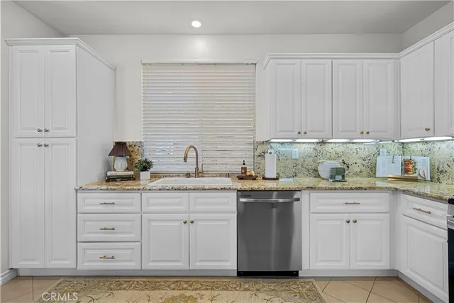 a kitchen with stainless steel appliances granite countertop a sink and cabinets