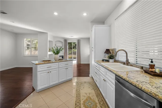 a large kitchen with a sink and cabinets