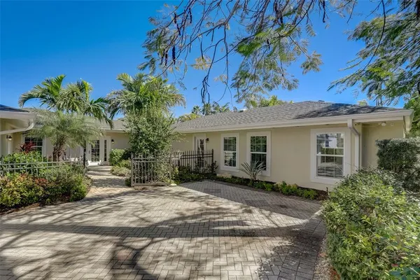 a view of a house with a tree and garden
