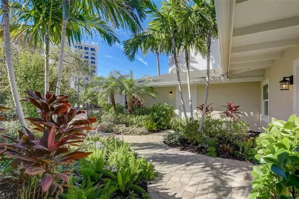 a view of a dining room and livingroom with furniture wooden floor a chandelier
