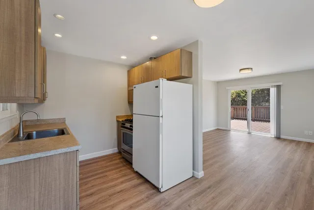 a kitchen with a stove and a refrigerator