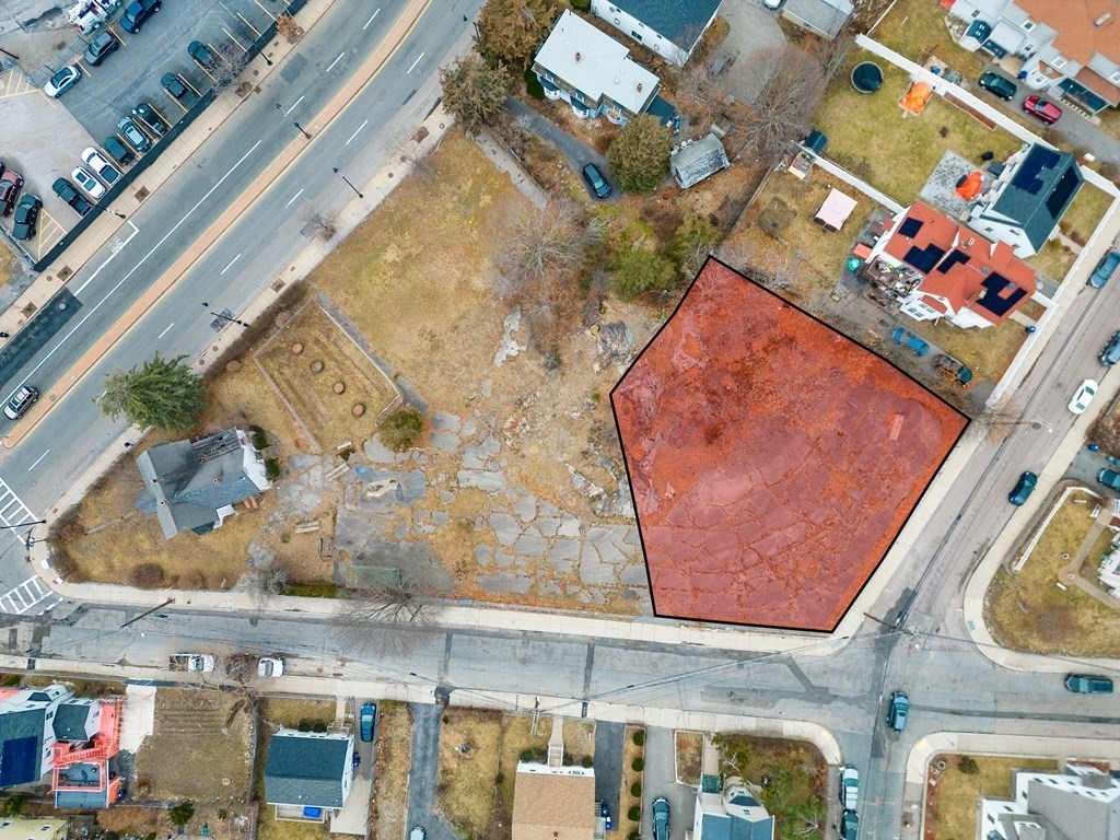 an aerial view of a building with parking