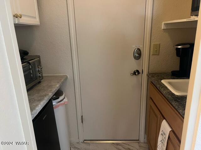 2820 Sports Village Loop Pinetop, AZ 85935 - Photo 22 of 24 a bathroom with a granite countertop sink and a washing machine