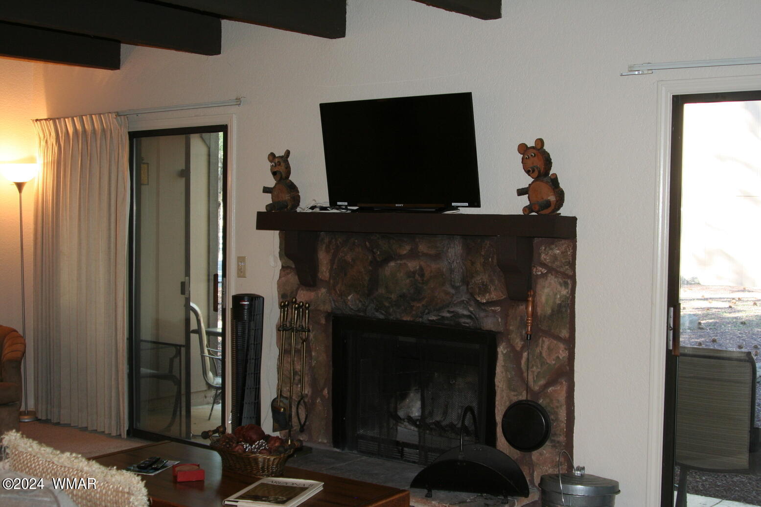 2820 Sports Village Loop Pinetop, AZ 85935 - Photo 4 of 24 a living room with a fireplace a flat screen tv and a window
