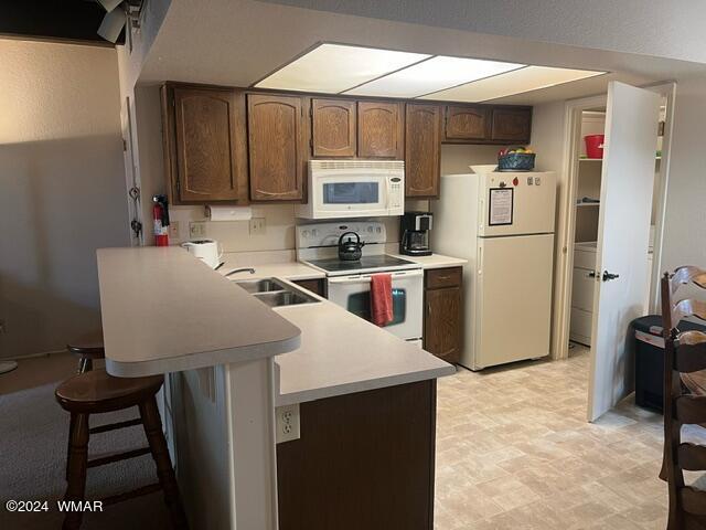 2820 Sports Village Loop Pinetop, AZ 85935 - Photo 8 of 24 a kitchen with a sink a refrigerator and cabinets