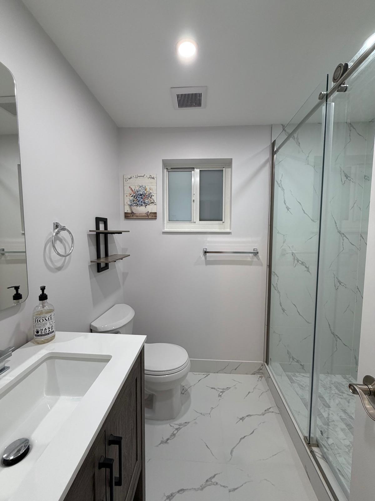 219 South Bay Harbor Drive, Unit B Key Largo, FL 33037 - Photo 11 of 16 a bathroom with a sink toilet and shower