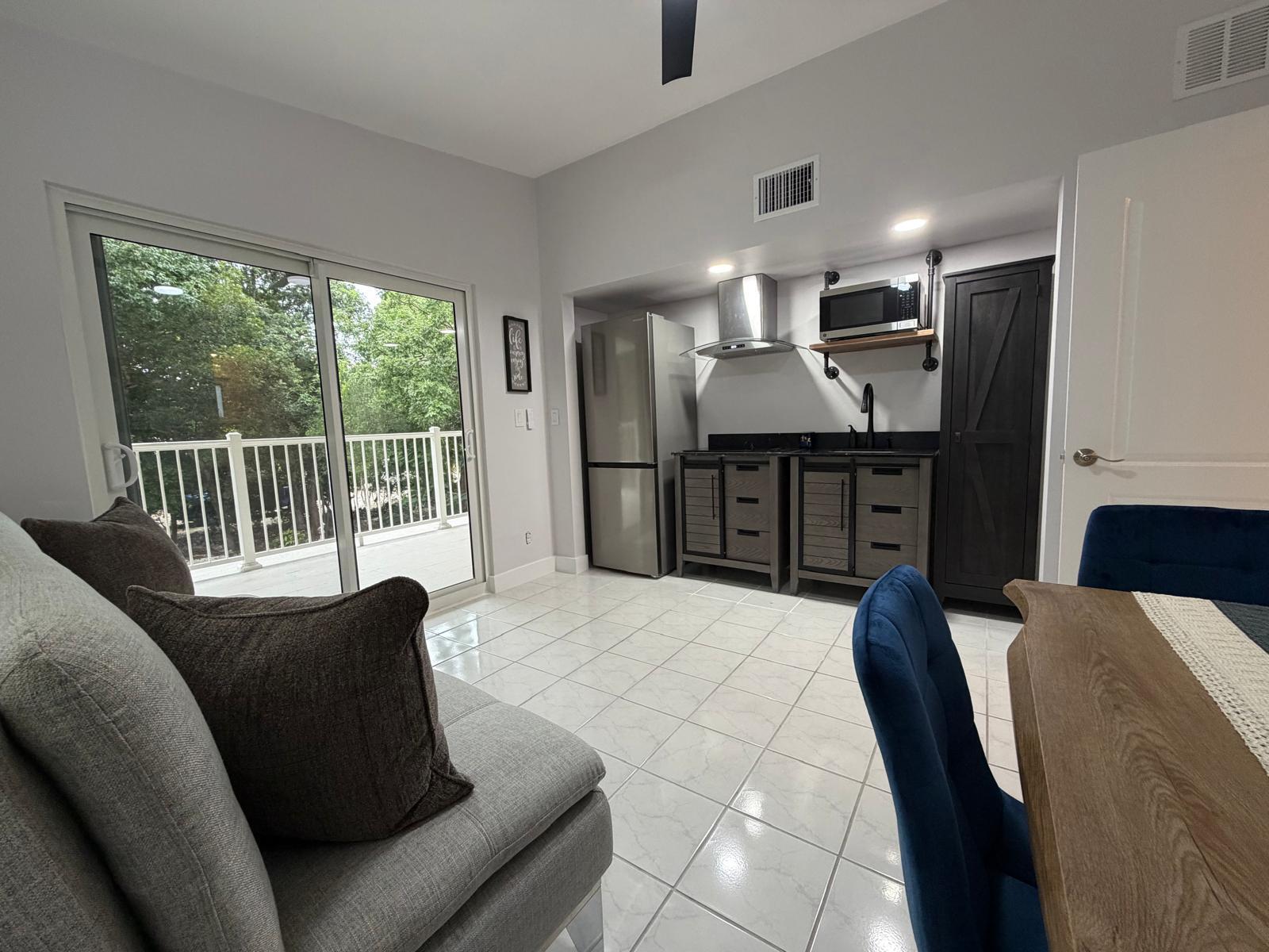 219 South Bay Harbor Drive, Unit B Key Largo, FL 33037 - Photo 4 of 16 a living room with furniture and kitchen view