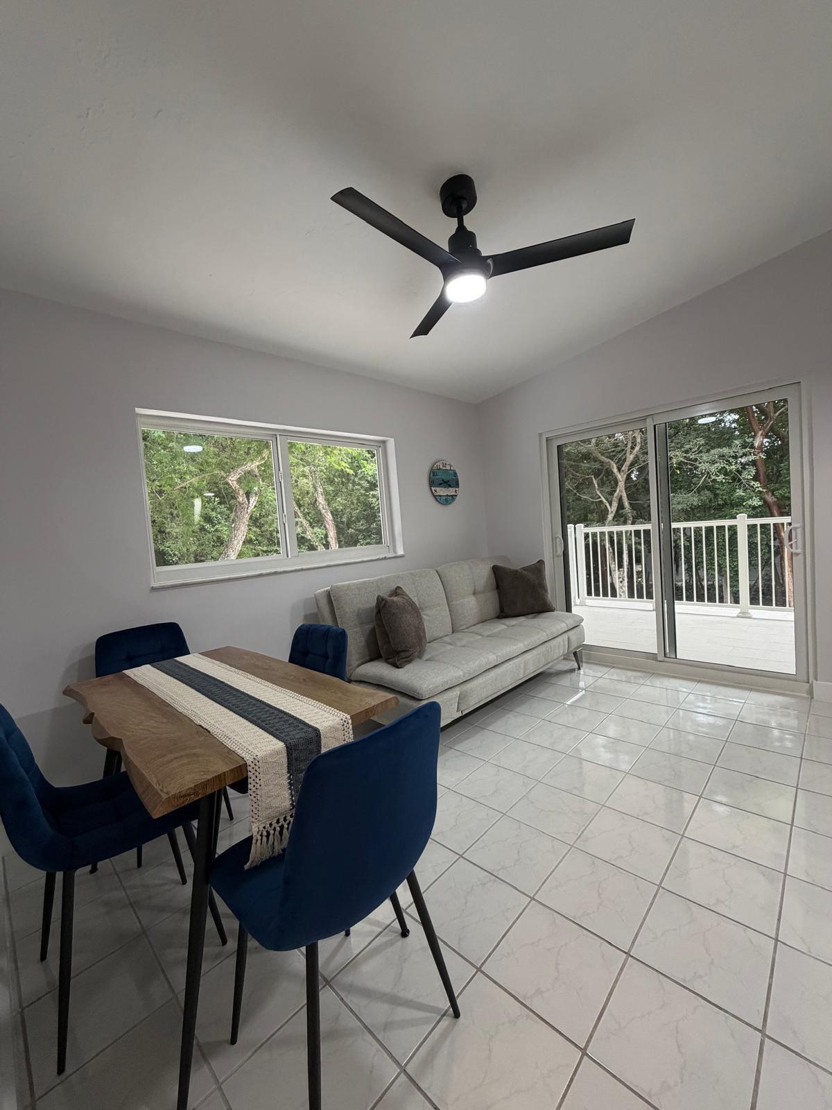 219 South Bay Harbor Drive, Unit B Key Largo, FL 33037 - Photo 5 of 16 a living room with furniture and a window