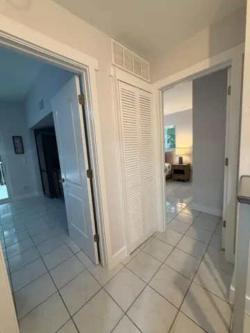 a view of hallway with a couch and a view of bathroom
