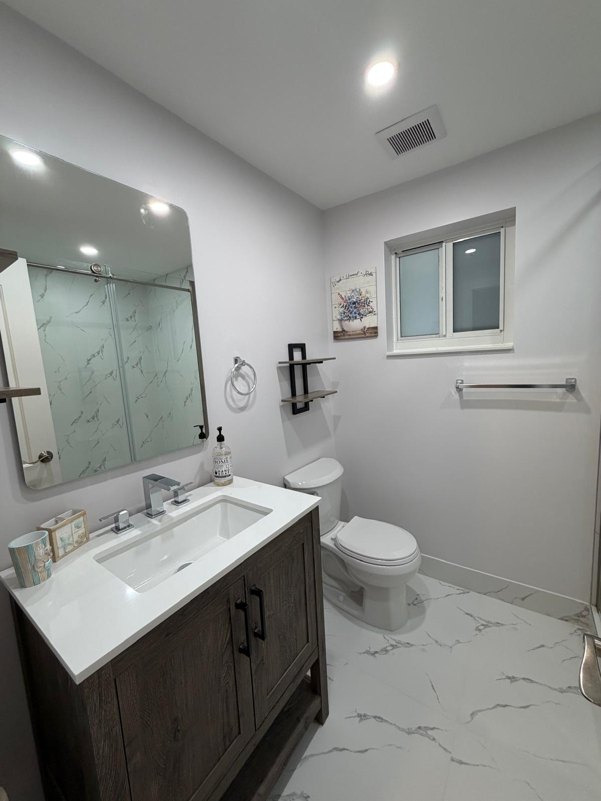219 South Bay Harbor Drive, Unit B Key Largo, FL 33037 - Photo 10 of 16 a bathroom with a sink toilet and mirror