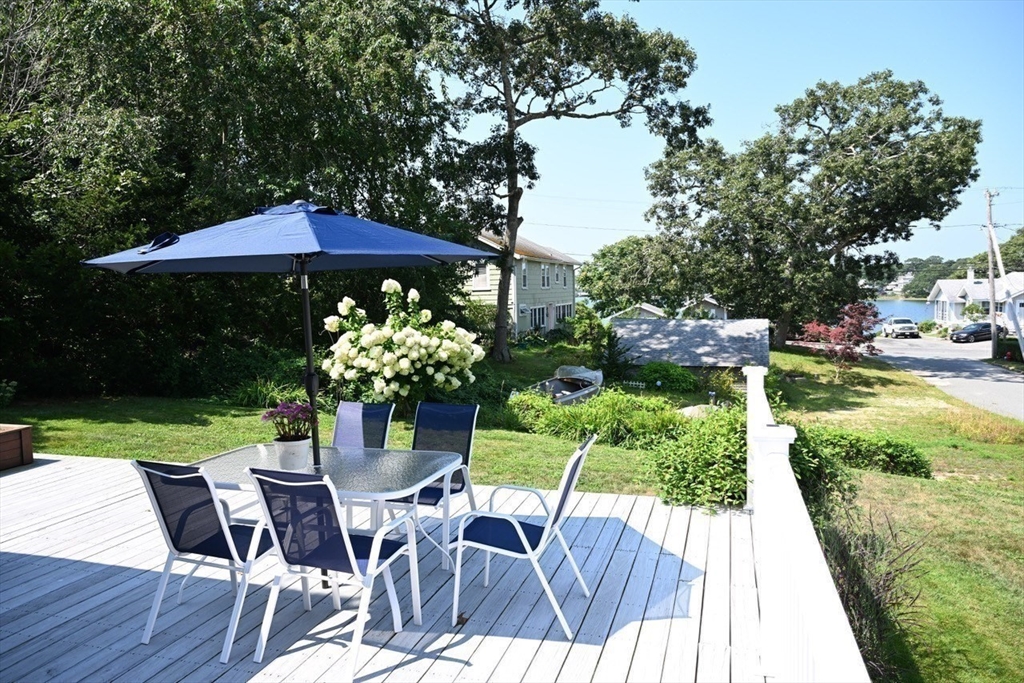 7 Glendale Road Wareham, MA 02558 - Photo 7 of 27 a view of a table and chairs under an umbrella