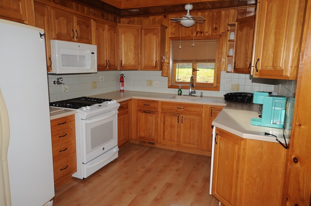 7 Glendale Road Wareham, MA 02558 - Photo 8 of 27 a kitchen with stainless steel appliances a stove a sink a refrigerator and cabinets