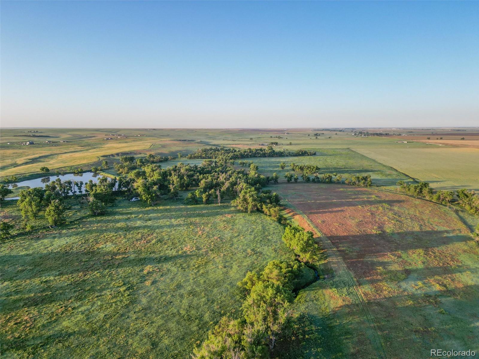 Pass Me By Road Strasburg, CO 80136 - Photo 11 of 46 a view of a lake with a city