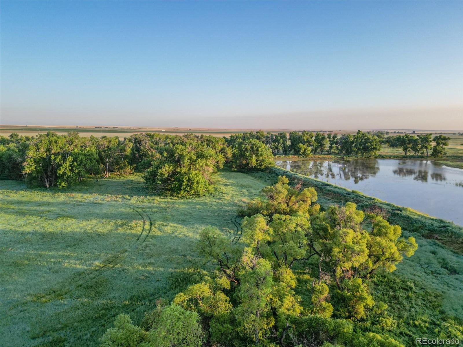 Pass Me By Road Strasburg, CO 80136 - Photo 25 of 46 a view of a lake with a yard