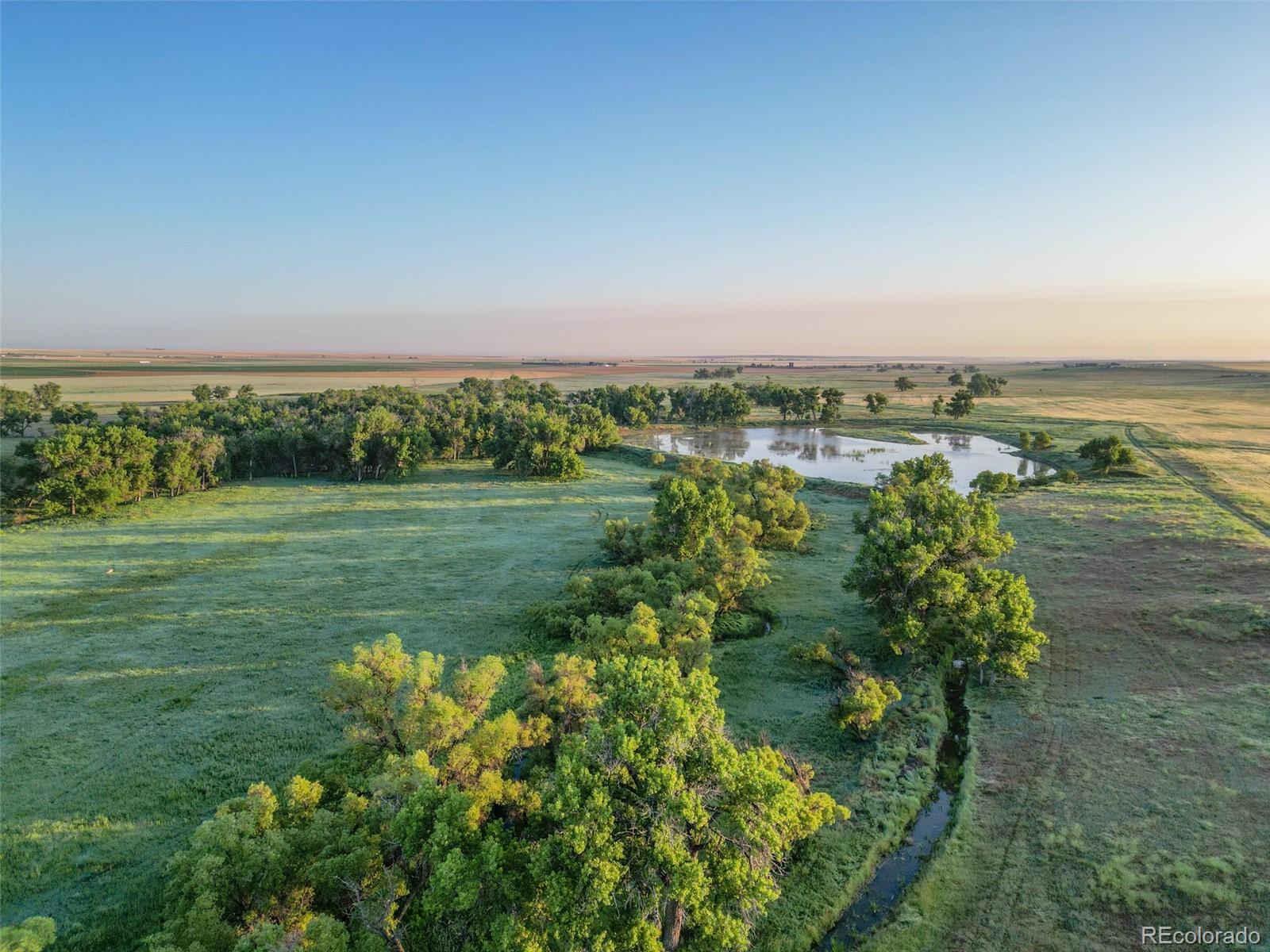 Pass Me By Road Strasburg, CO 80136 - Photo 29 of 46 a view of a lake with a big yard