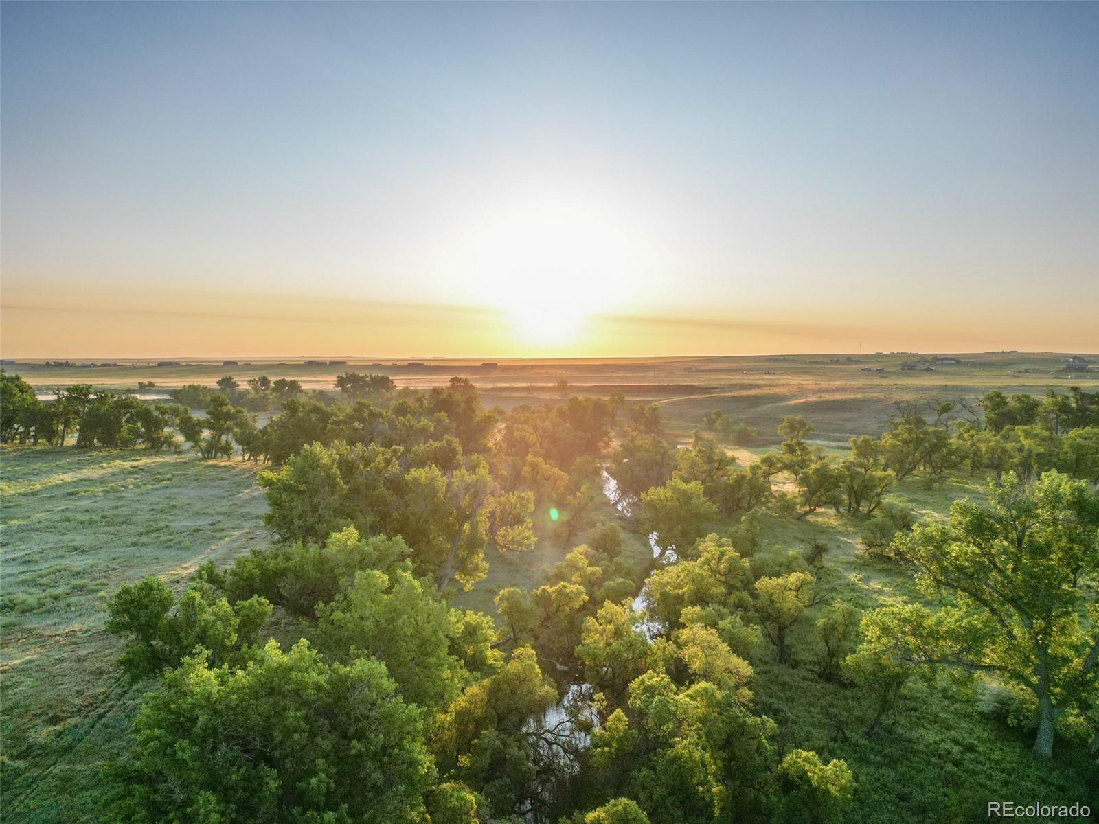 Pass Me By Road Strasburg, CO 80136 - Photo 34 of 46 an aerial view of residential houses with outdoor space and trees