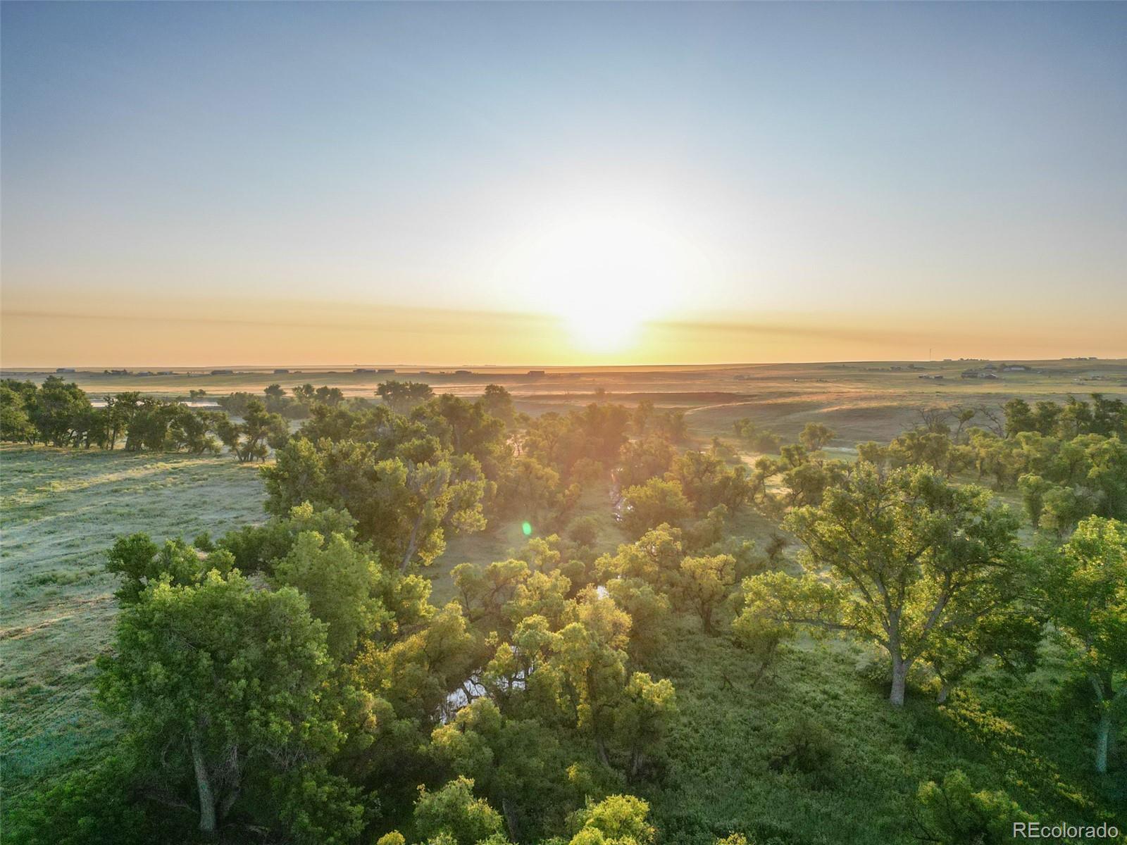 Pass Me By Road Strasburg, CO 80136 - Photo 35 of 46 an aerial view of residential houses with outdoor space and trees