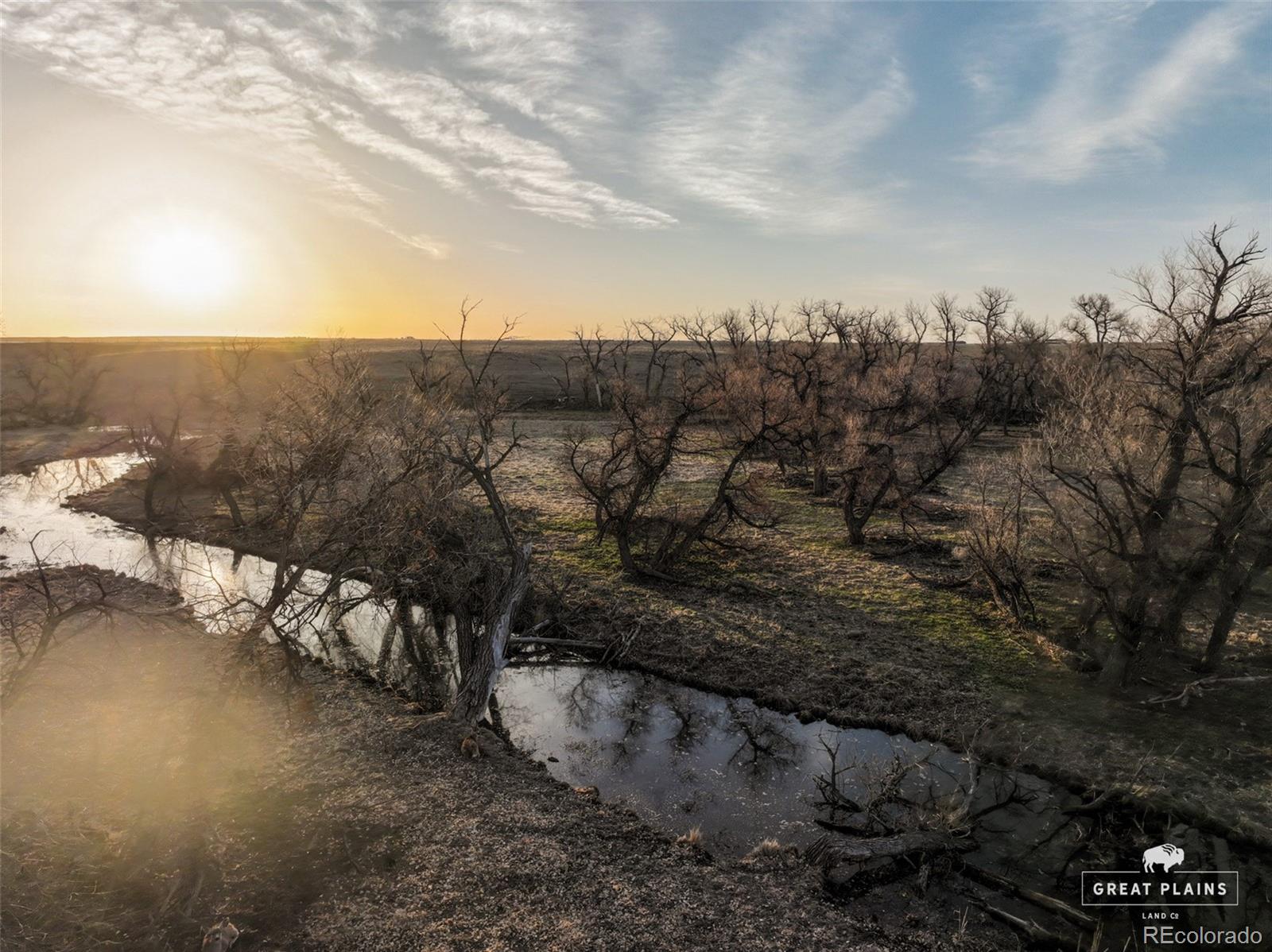 Pass Me By Road Strasburg, CO 80136 - Photo 43 of 46 a view of a yard with wooden fence