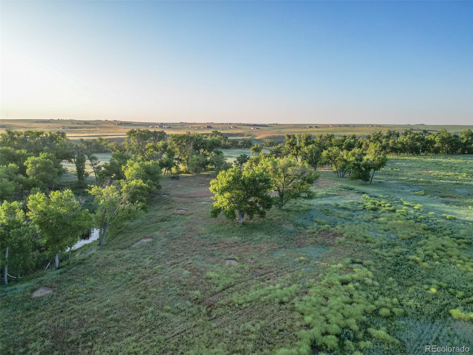 Pass Me By Road Strasburg, CO 80136 - Photo 8 of 46 a view of a field with an ocean