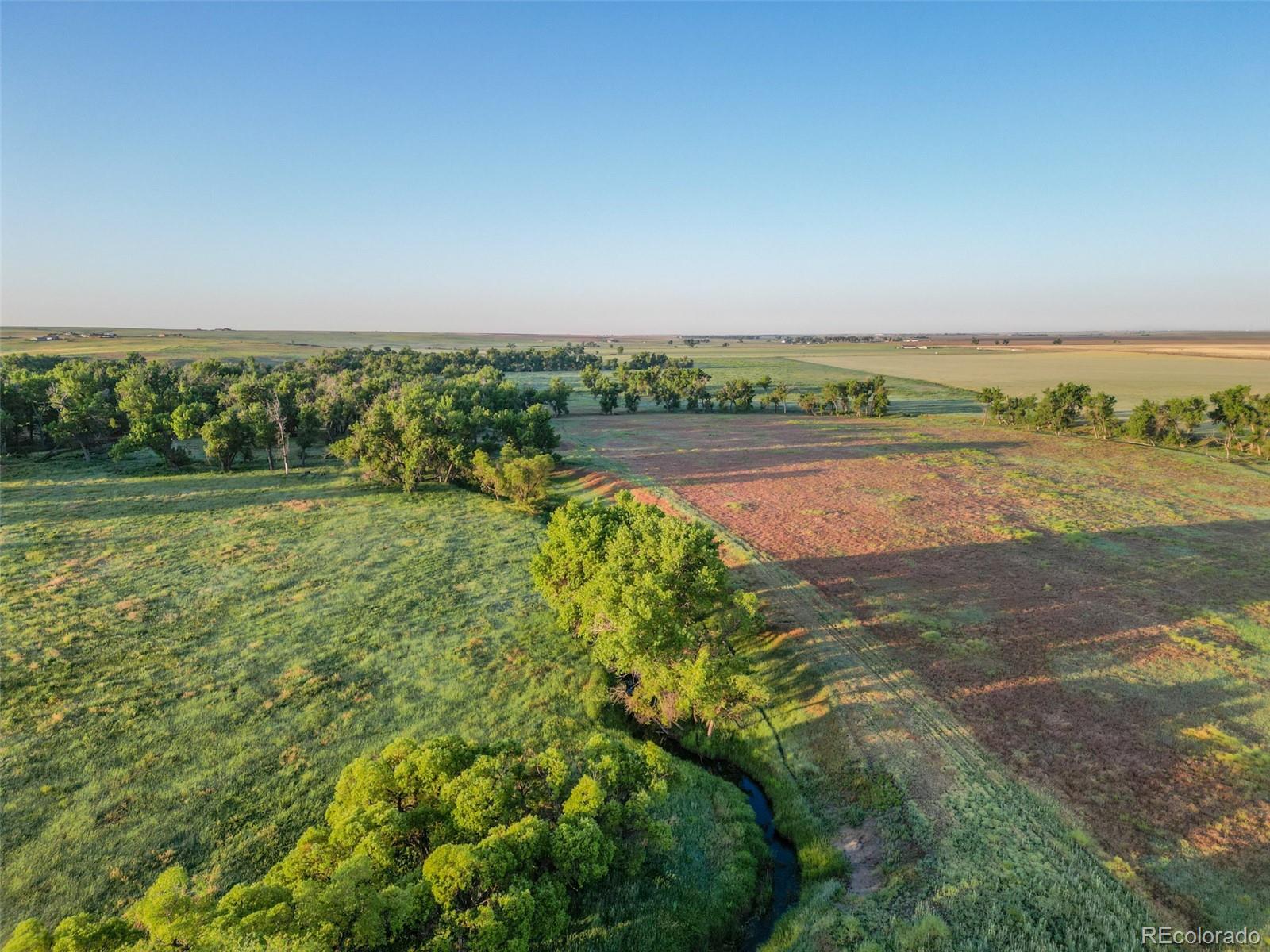 Pass Me By Road Strasburg, CO 80136 - Photo 10 of 46 a view of an outdoor space and a lake view