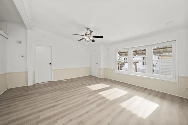 wooden floor in an empty room with a window