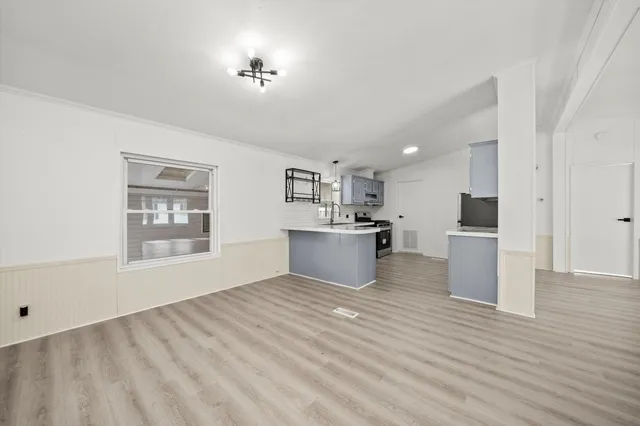 a view of kitchen with furniture and wooden floor