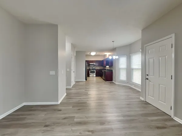 a view of a livingroom with a kitchen and a stove