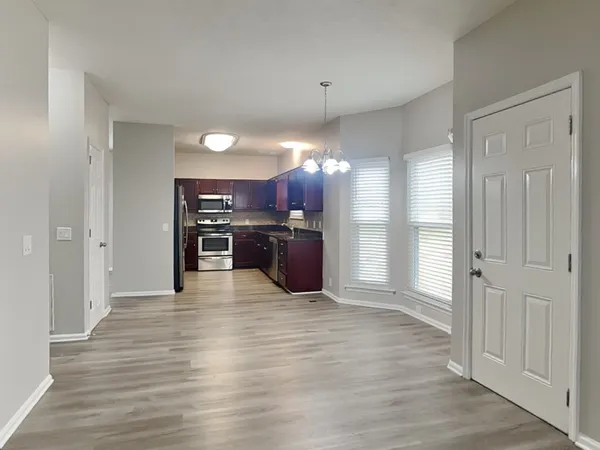 a view of a kitchen with a refrigerator and a stove top oven