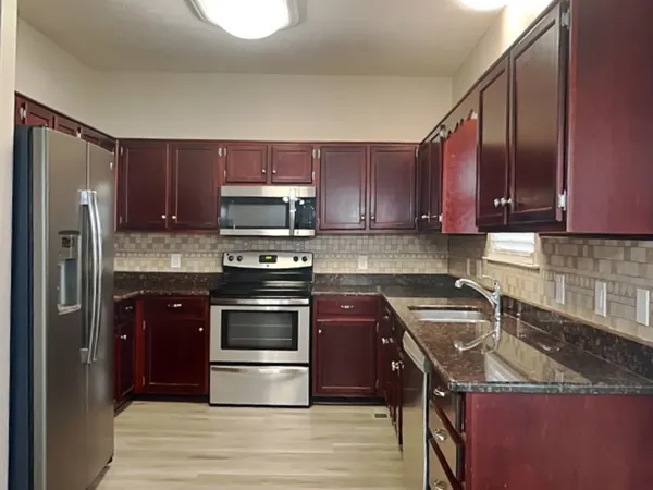 a kitchen with a sink appliances and cabinets