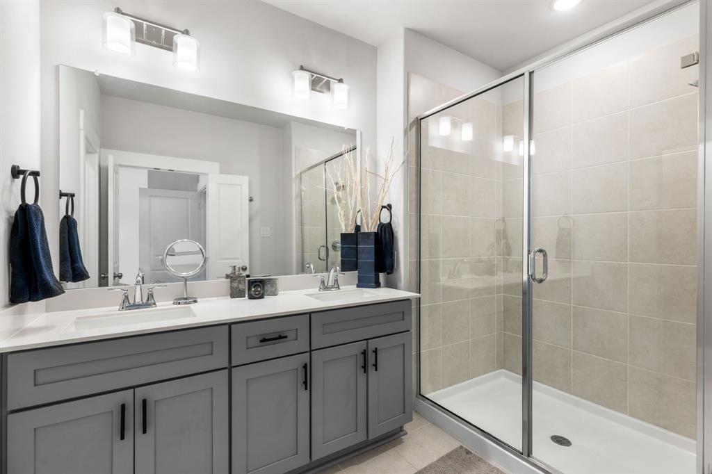 4502 Smokey Quartz Lane Arlington, TX 76005 - Photo 20 of 32 a bathroom with a double vanity sink mirror and shower