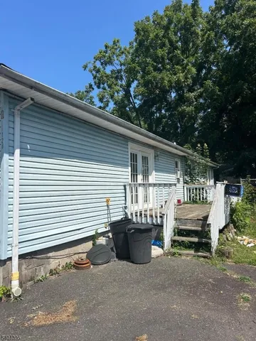a view of a chair and tables in the back yard